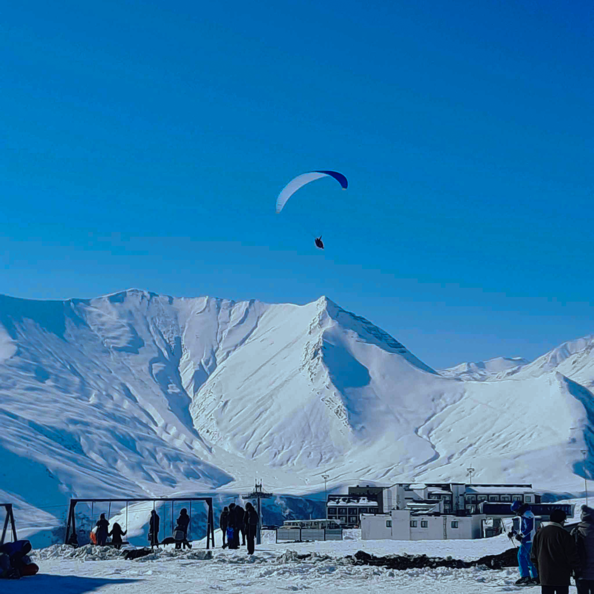Winter season paragliding gudauri background
